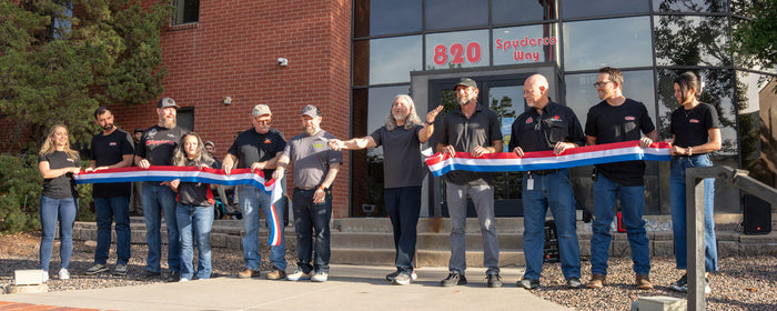 A ribbon being cut by Eric Glesser